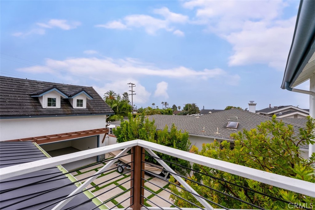 Bedroom with balcony overlooking back yard and pool. - 26882 Calle Real, Dana Point CA 92624 - photo 29