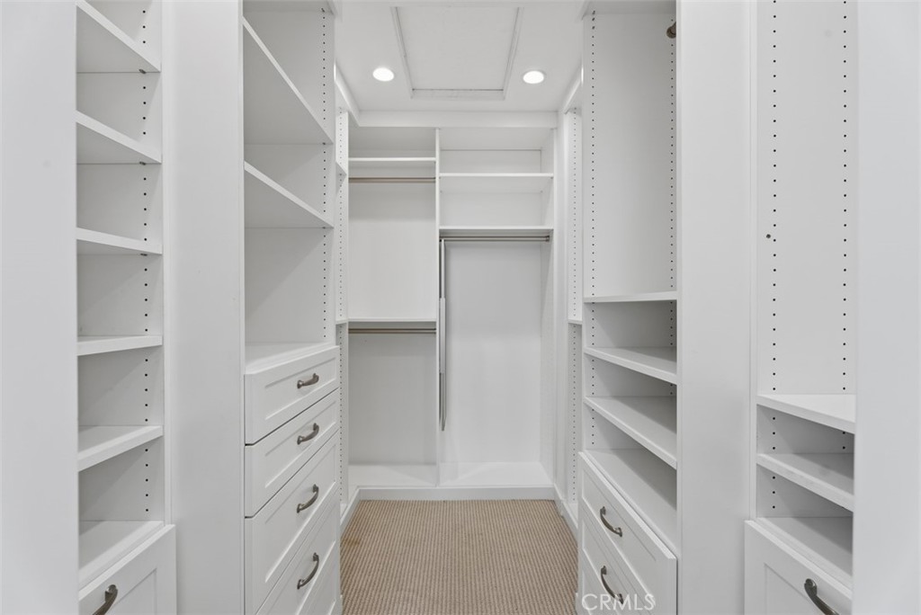 Primary bedroom with thoughfully designed walk-in closet, ample built-in storage. - 26882 Calle Real, Dana Point CA 92624 - photo 38
