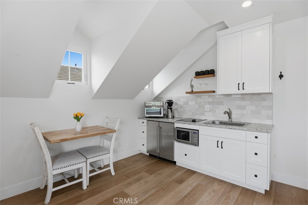 ADU kitchen, fully self contained, table that folds down and flush to the wall, sink with garbage disposal, 2 burner sto - 26882 Calle Real, Dana Point CA 92624 - photo 48