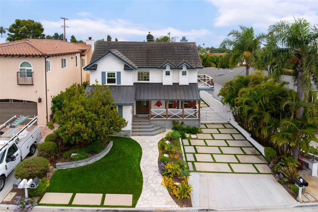 Drone view front of house, showing off the beautiful porch and nicely decorated yard space. Stunning curb appeal and lus - 26882 Calle Real, Dana Point CA 92624 - photo 50