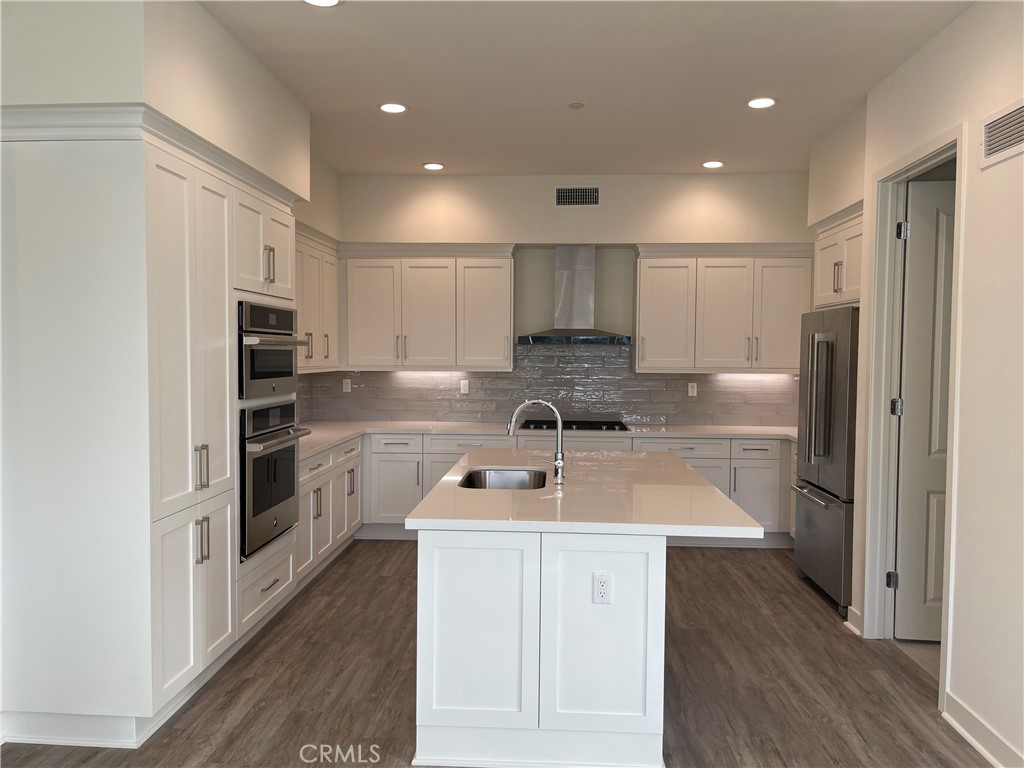 Gorgeous island kitchen with quartz counters and stainless steel appliances. - 3211 Doheny Way, Dana Point CA 92629 - photo 1