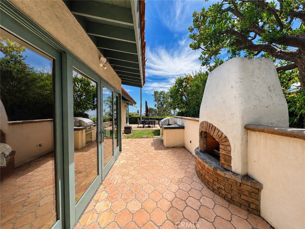 Sliding doors from the primary suite to your own outdoor fireplace - 32355 Via Antibes, Dana Point CA 92629 - photo 26