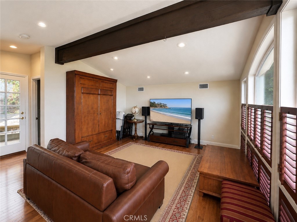 A multipurpose room with ocean views, a sofa, bed, and Murphy bed. - 32355 Via Antibes, Dana Point CA 92629 - photo 43