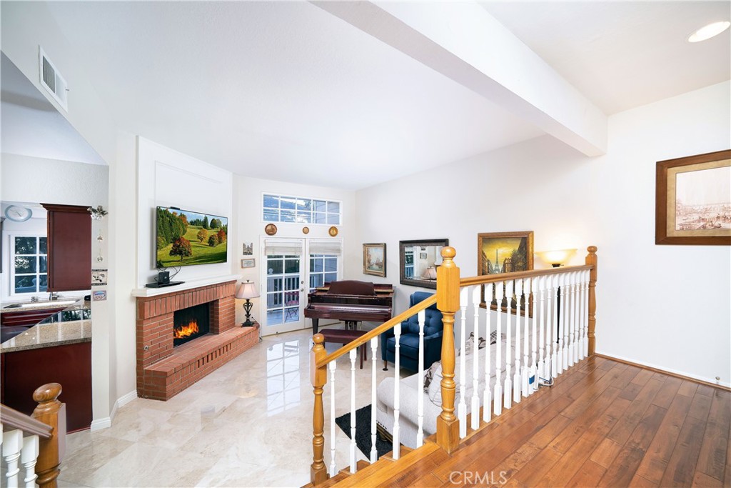Stairs leading into the living room with fireplace - 33204 Ocean Bright 11, Dana Point CA 92629 - photo 1