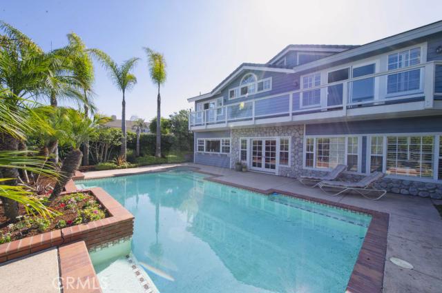 Pool and spa with sitting area and steps. Overhead is balcony that runs the length of the home. - 33262 Astoria Street, Dana Point CA 92629 - photo 1