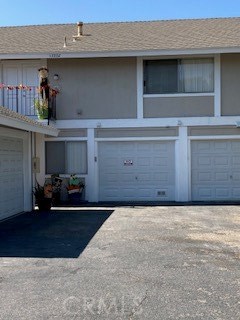 This is the back entrance, middle garage belongs to this unit, plus one assigned parking space. - 33332 Nottingham Way 2, Dana Point CA 92629 - photo 1