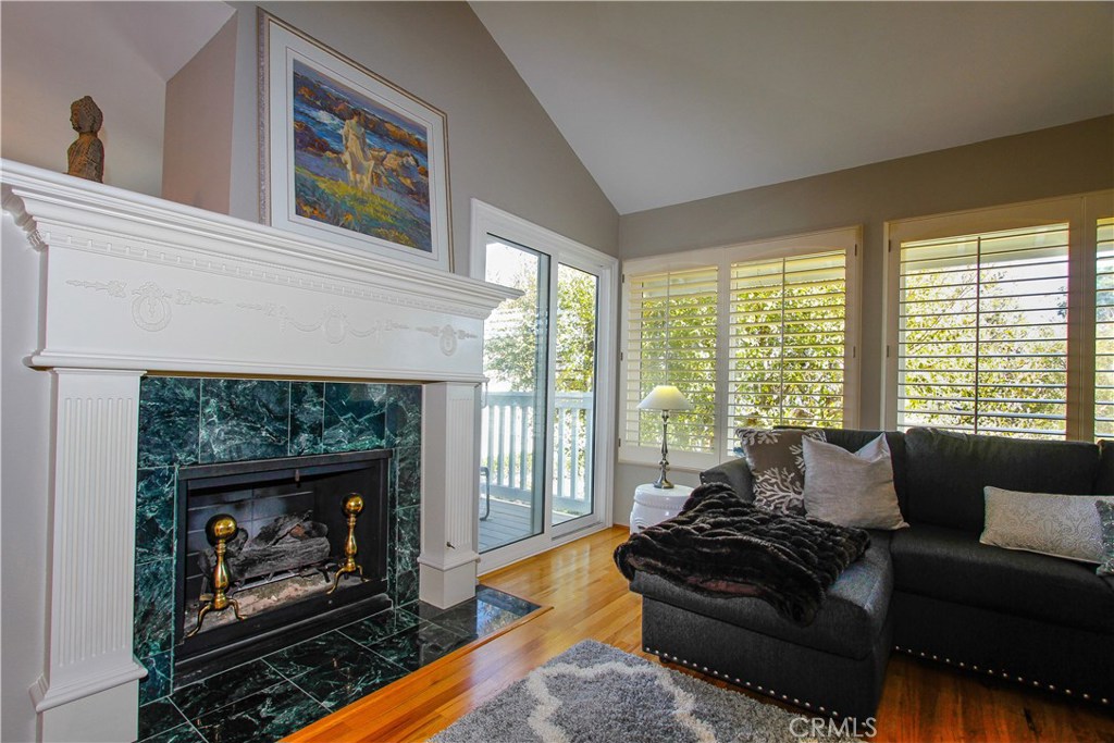 Vaulted ceilings in gorgeous living room with fire place. Also note the door leading to the back patio. You are surround - 33542 Sea Gull Court, Dana Point CA 92629 - photo 1