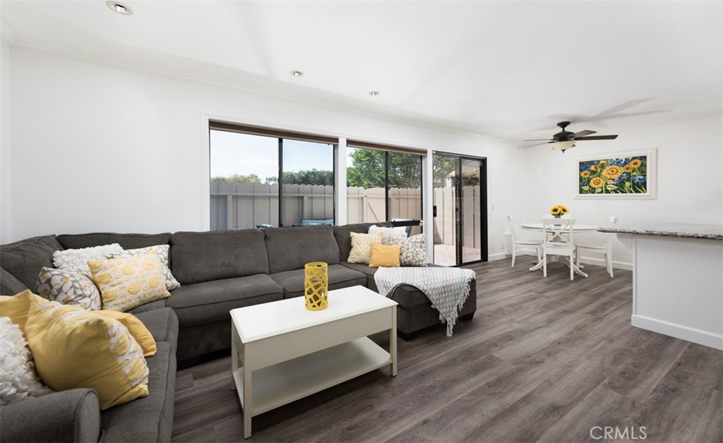 Open floor plan to living room, kitchen, dining nook, and patio area. - 33591 Avenida Capri 51, Dana Point CA 92629 - photo 1