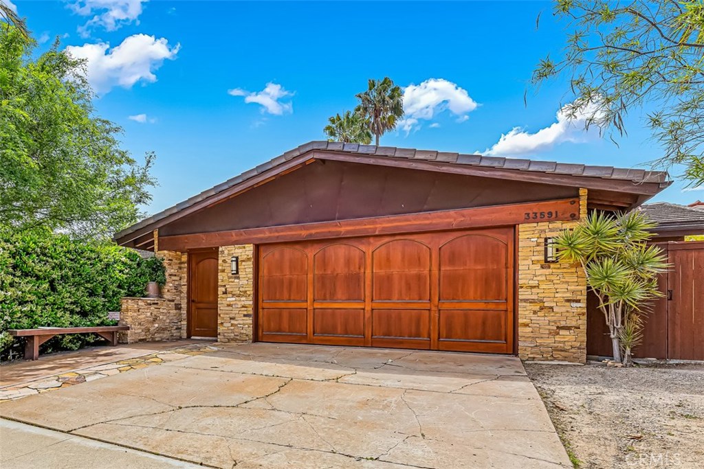 Private, Custom Home exudes warmth, nature and artistry. The entrance is a wonderful combination of exposed Douglas Fir - 33591 Big Sur Street, Dana Point CA 92629 - photo 1