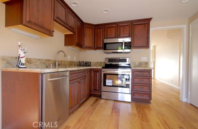 Upgraded Kitchen with stainless steel appliances, new cabinets (soft close), granite counter tops and under lighting. - 33612 Circula Corona, Dana Point CA 92629 - photo 1