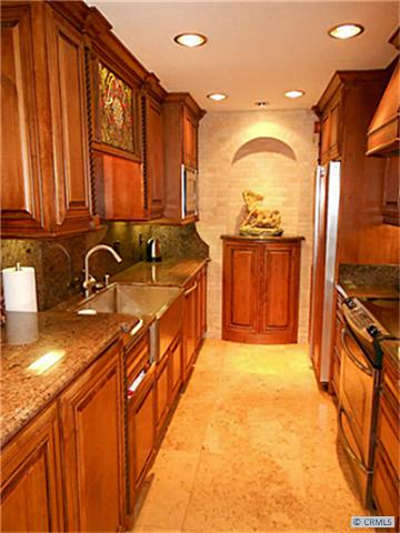 Amazing gourmet kitchen with countless upgrades! Custom cabinetry, 24" travertine tile, granite counters. - 33852 DEL OBISPO Street 104, Dana Point CA 92629 - photo 1