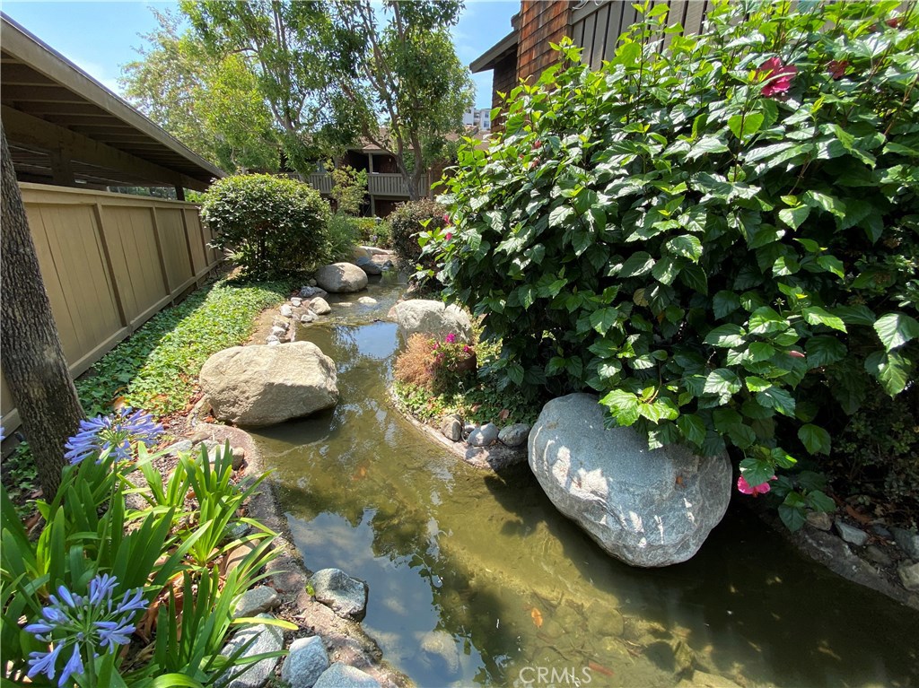 FRONT ENTRY.........MEANDERING STREAMS, MATURE TREES AND PLANTINGS THROUGHOUT COMMUNITY! - 33852 Del Obispo Street 53, Dana Point CA 92629 - photo 1