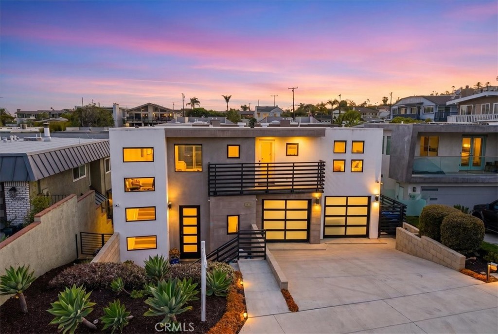 Twilight exterior view showcasing the home's striking contemporary architecture and inviting curb appeal. - 33871 Calle La Primavera, Dana Point CA 92629 - photo 2