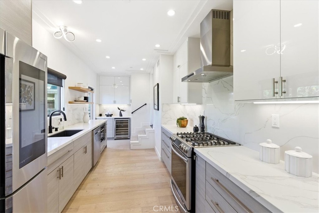 Modern kitchen showcasing sleek finishes, ample workspace, and abundant natural light throughout. - 33871 Calle La Primavera, Dana Point CA 92629 - photo 14