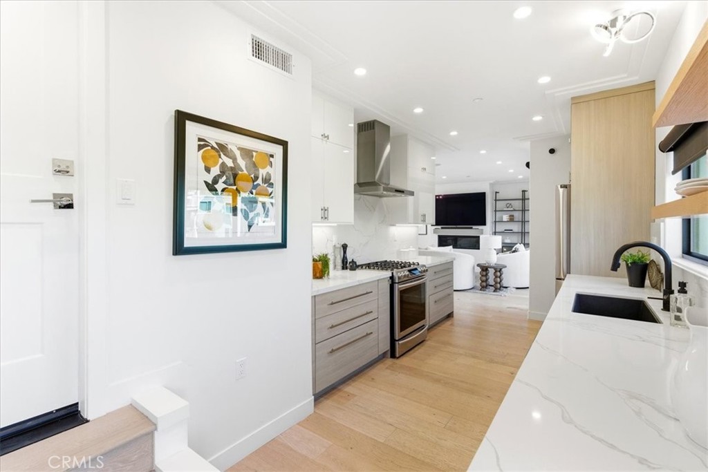 Bright kitchen interior featuring custom cabinetry, quality appliances, and clean contemporary design. - 33871 Calle La Primavera, Dana Point CA 92629 - photo 15