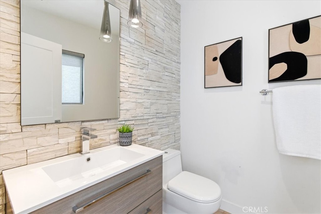 Stylish powder room featuring contemporary finishes, designer lighting, and a sleek modern aesthetic. - 33871 Calle La Primavera, Dana Point CA 92629 - photo 17