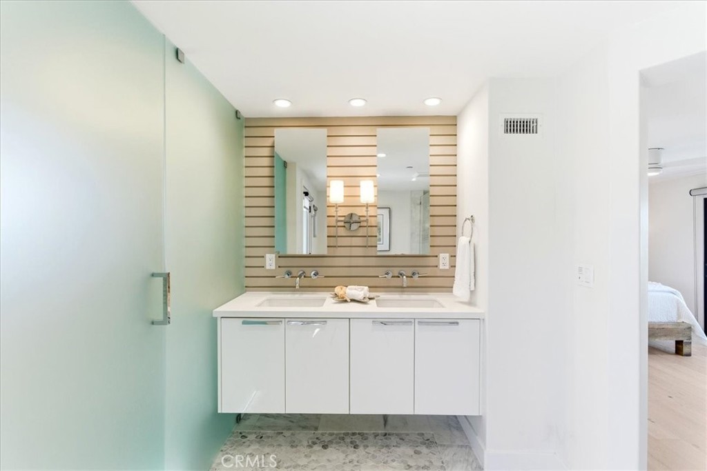 Dual-sink vanity with contemporary finishes, generous storage, and elegant lighting. - 33871 Calle La Primavera, Dana Point CA 92629 - photo 25