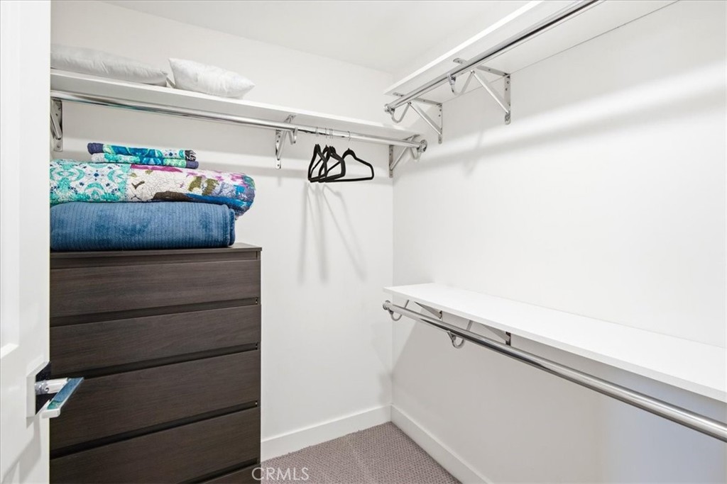 Walk-in closet offering built-in storage, shelving, and excellent organization space. - 33871 Calle La Primavera, Dana Point CA 92629 - photo 39