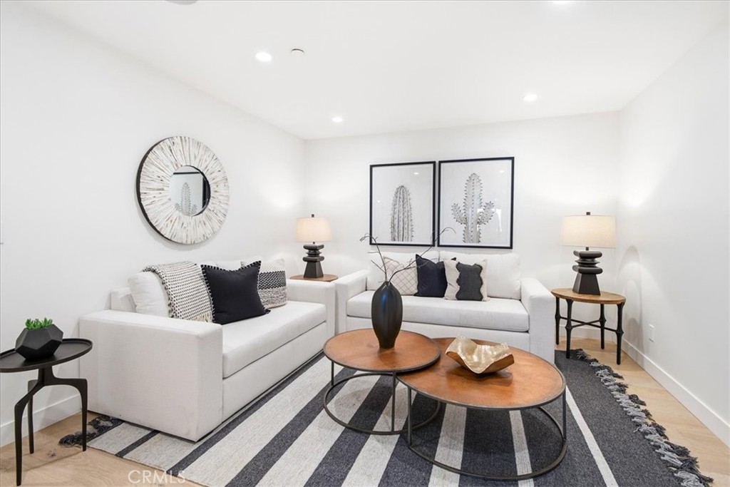 Lower-level family room featuring comfortable seating and a welcoming space for relaxation and entertainment. - 33871 Calle La Primavera, Dana Point CA 92629 - photo 40