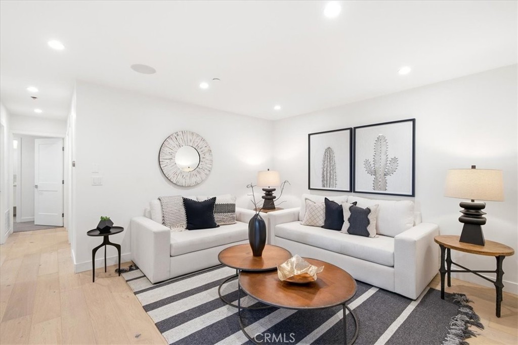Living room with light hardwood floors and staged seating. - 33871 Calle La Primavera, Dana Point CA 92629 - photo 6