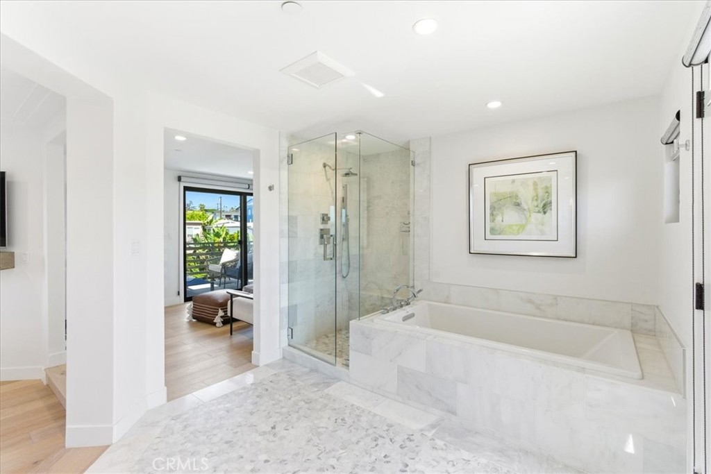 Bathroom with a soaking tub, walk-in shower, and balcony access. - 33871 Calle La Primavera, Dana Point CA 92629 - photo 17