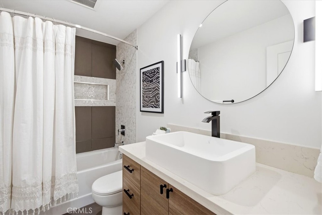 Bathroom with a vessel sink and shower curtain. - 33871 Calle La Primavera, Dana Point CA 92629 - photo 20