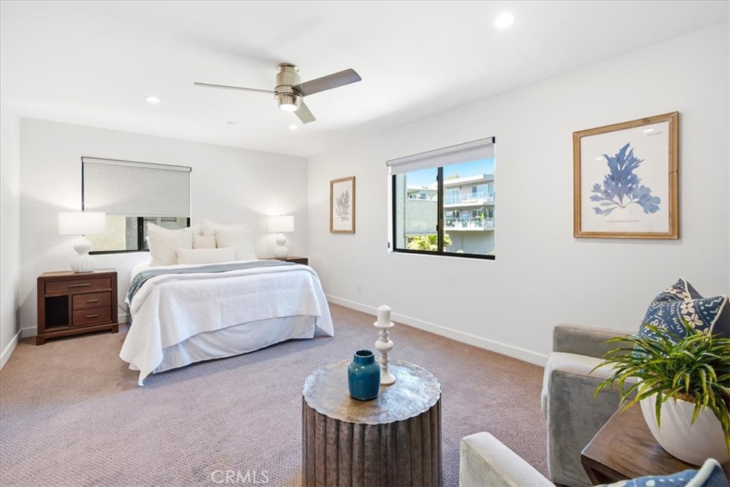Bedroom with a ceiling fan and a sitting area. - 33871 Calle La Primavera, Dana Point CA 92629 - photo 25