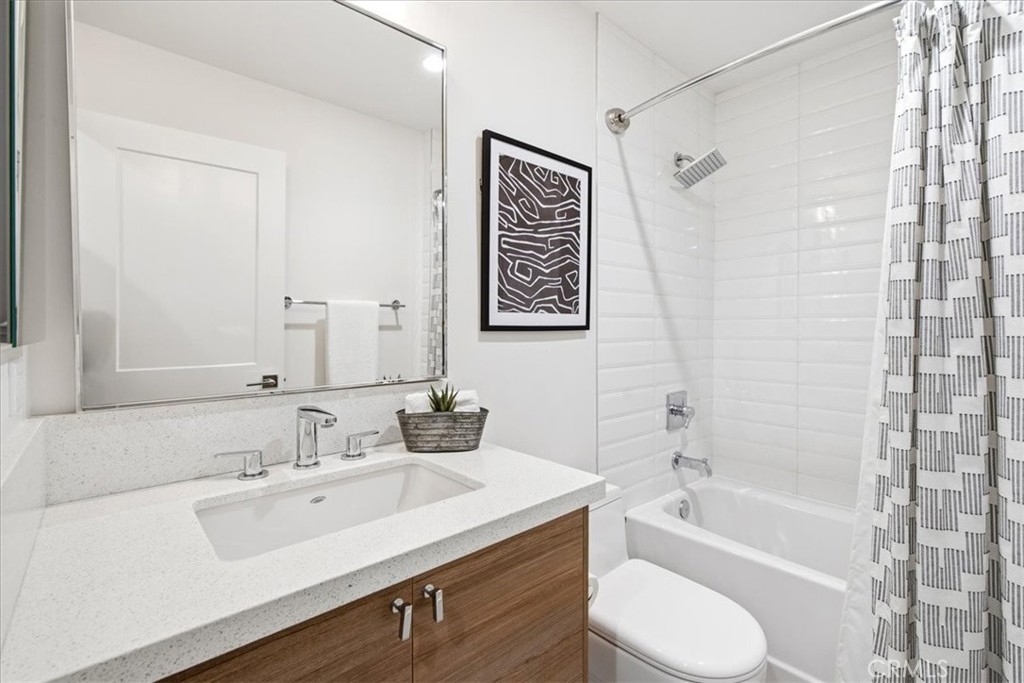 Bathroom with a tub-shower and wood vanity. - 33871 Calle La Primavera, Dana Point CA 92629 - photo 26