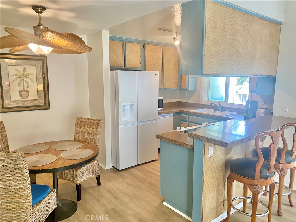 Coastal beachy themed kitchen and dining area. Refrigerator, dishwasher, and microwave included. - 34042 Selva RD 139, Dana Point CA 92629 - photo 1