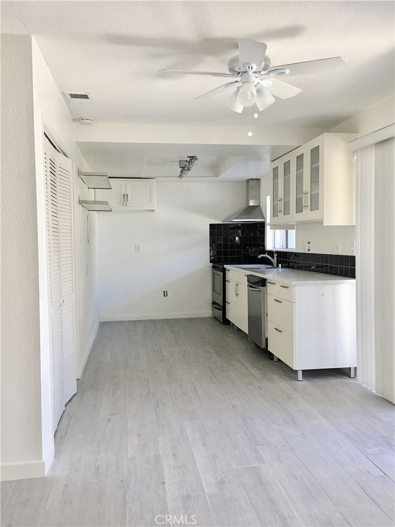 KITCHEN WITH STAINLESS STEEL APPLIANCES AND QUARTZ COUNTERS. - 34096 Alcazar Drive A, Dana Point CA 92629 - photo 1