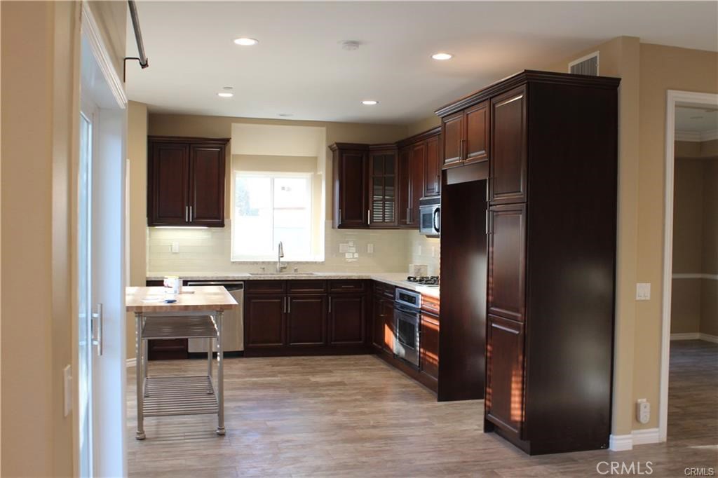 Updated kitchen with quartz counter-tops and dark wood cabinetry - 34111 Mazo Drive, Dana Point CA 92629 - photo 1
