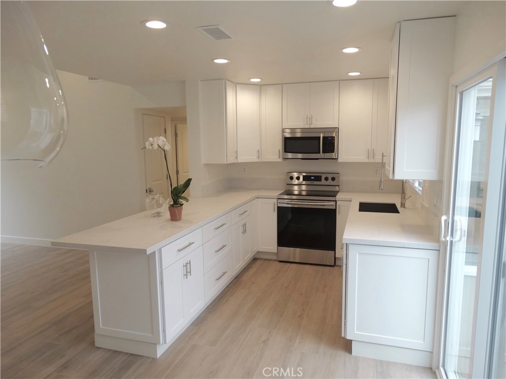 Beautiful new Kitchen with Carrera marble counter tops and new stainless steel appliances - 34138 Selva Road 225, Dana Point CA 92629 - photo 1