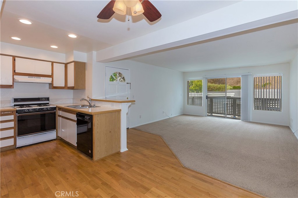 Entry to family room w/ deck, kitchen and dining. - 34264 Camino Capistrano 220, Dana Point CA 92624 - photo 1