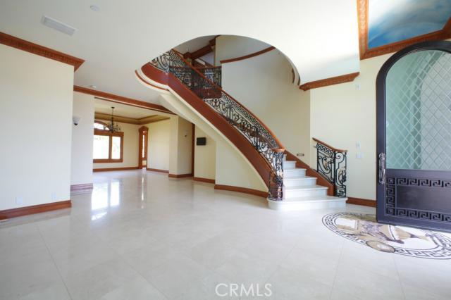 Beautiful oversized beveled glass door leads to great room. Intricate Iron railing complments the custom stair well. - 34752 Doheny Place, Dana Point CA 92624 - photo 1