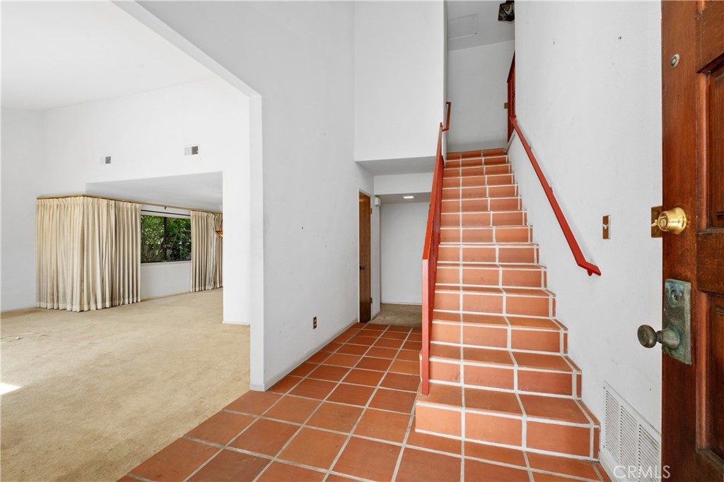 Stairs up and step down formal living room - 34866 Doheny Place, Dana Point CA 92624 - photo 7