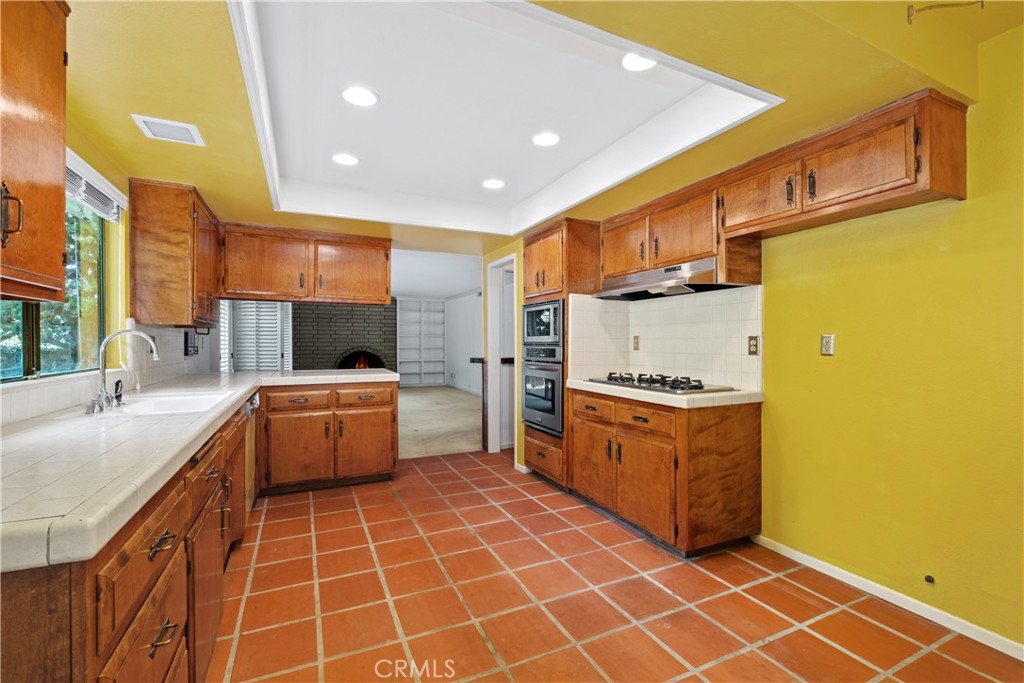 Kitchen leading to family room with fireplace - 34866 Doheny Place, Dana Point CA 92624 - photo 18