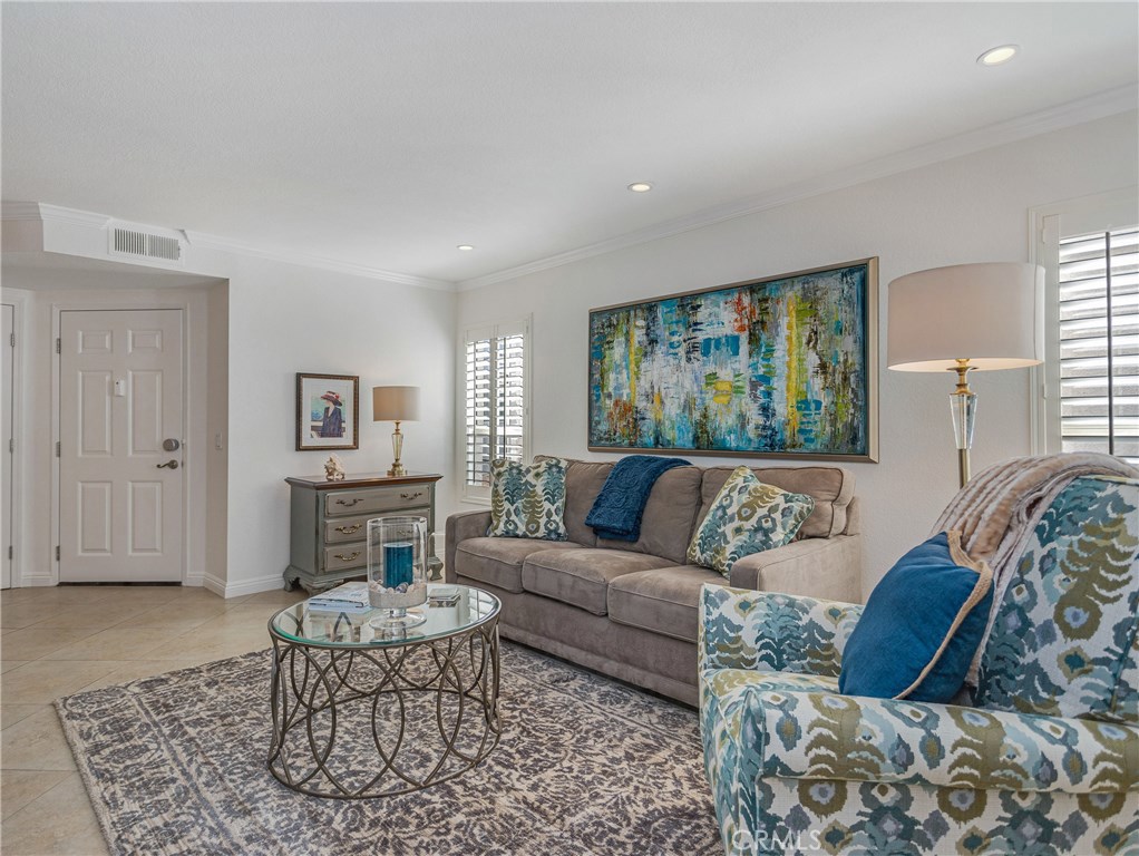 The abundant sun-filled living area with recessed lighting, tile flooring and shuttered windows...the perfect place to c - 50 Corniche Drive F, Dana Point CA 92629 - photo 1