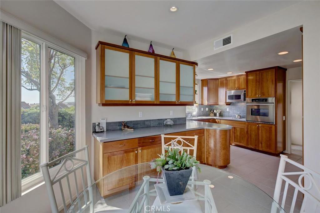 Beautiful remodeled kitchen with Cherry wood cabinets and Silestone Quartz counters. The cabinets were extended into the - 62 Los Cabos, Dana Point CA 92629 - photo 1
