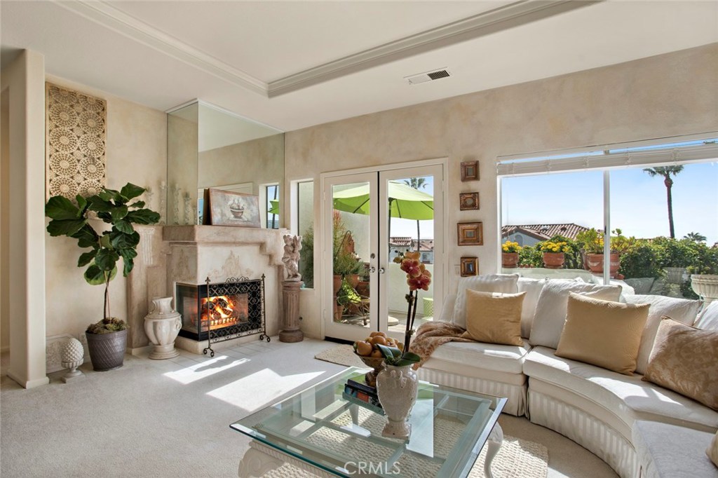 Warm and inviting living room which leads to breezy balcony. - 63 Tennis Villas Drive, Dana Point CA 92629 - photo 1