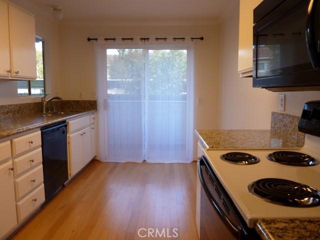 Large eat-in kitchen with plentiful counter space and cabinet storage. - 70 Corniche Drive B, Dana Point CA 92629 - photo 1
