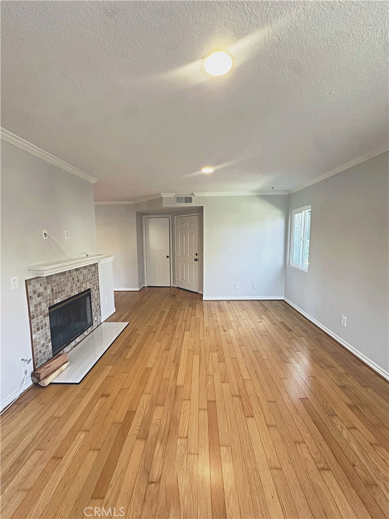 Light and bright family room with real wood floors and newly refinished fireplace. - 70 Corniche, Dana Point CA 92629 - photo 3