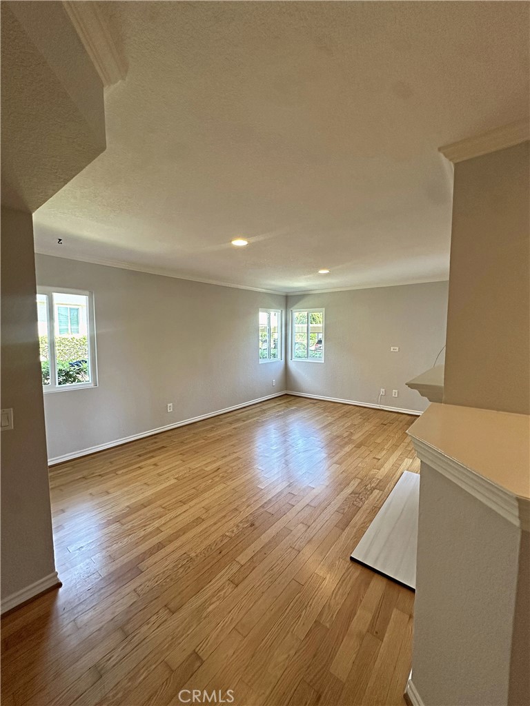 Light and bright family room with real wood floors and newly refinished fireplace. - 70 Corniche, Dana Point CA 92629 - photo 4