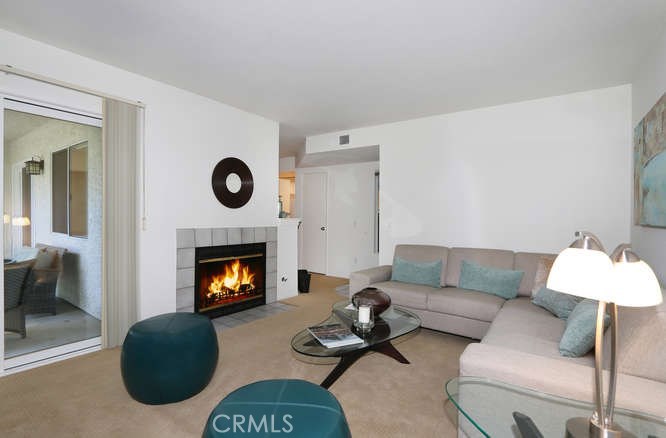 Spacious living room with access to second patio and romantic fireplace - 8 Corniche Drive B, Dana Point CA 92629 - photo 1