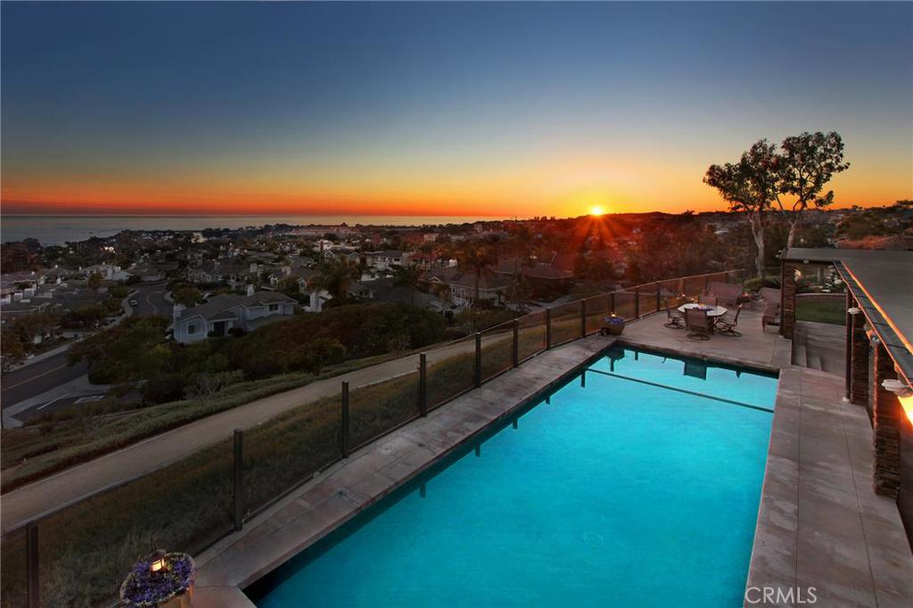 This stunning view is awaiting you in the backyard of this unique estate situated behind gates. Enjoy the sunset over th - 9 Cobalt Drive, Dana Point CA 92629 - photo 1