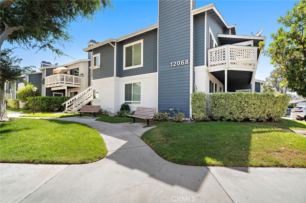 Beautifully maintained Cape Cod-style exterior with lush landscaping, manicured greenbelts, and inviting walkways. - 12068 Sylvan River 58, Fountain Valley CA 92708 - photo 1