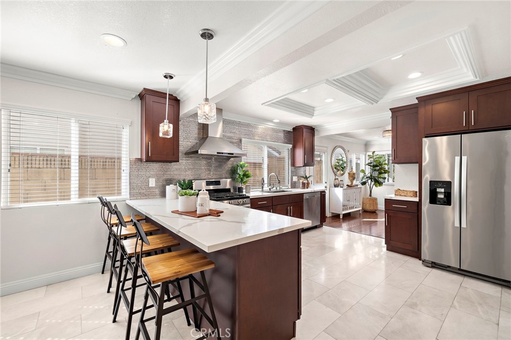 Quartz countertops, generous prep and storage space, a large breakfast bar - 17925 Mount Coulter, Fountain Valley CA 92708 - photo 13