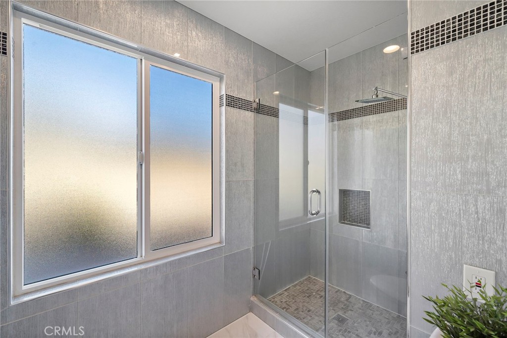 Primary bath with floor to ceilings tile and multi-shower heads - 17925 Mount Coulter, Fountain Valley CA 92708 - photo 21