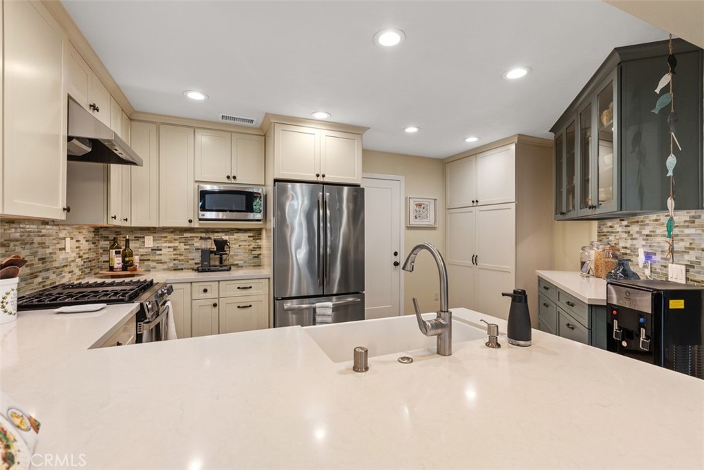 Remodeled kitchen with barn sink. - 18261 Sanmian Court, Fountain Valley CA 92708 - photo 11