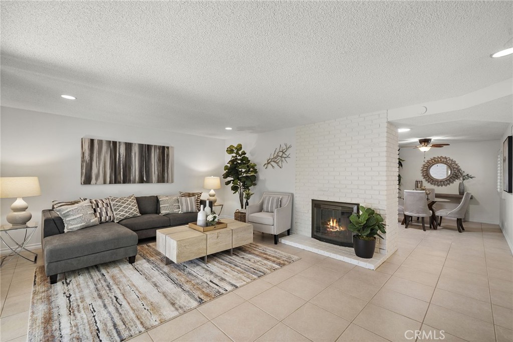 Large living room with cozy brick fireplace - 18474 Tamarind Street, Fountain Valley CA 92708 - photo 10