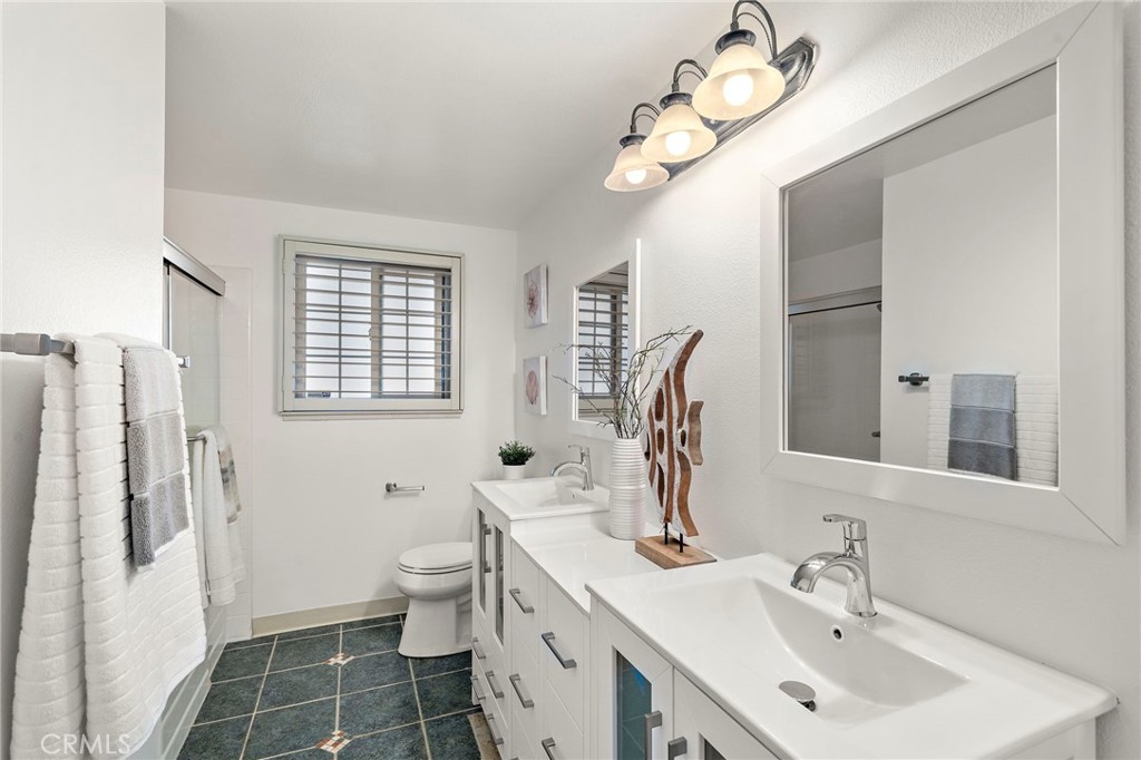 Refreshed with a new dual sink vanity and glass shower enclosure - 18474 Tamarind Street, Fountain Valley CA 92708 - photo 23